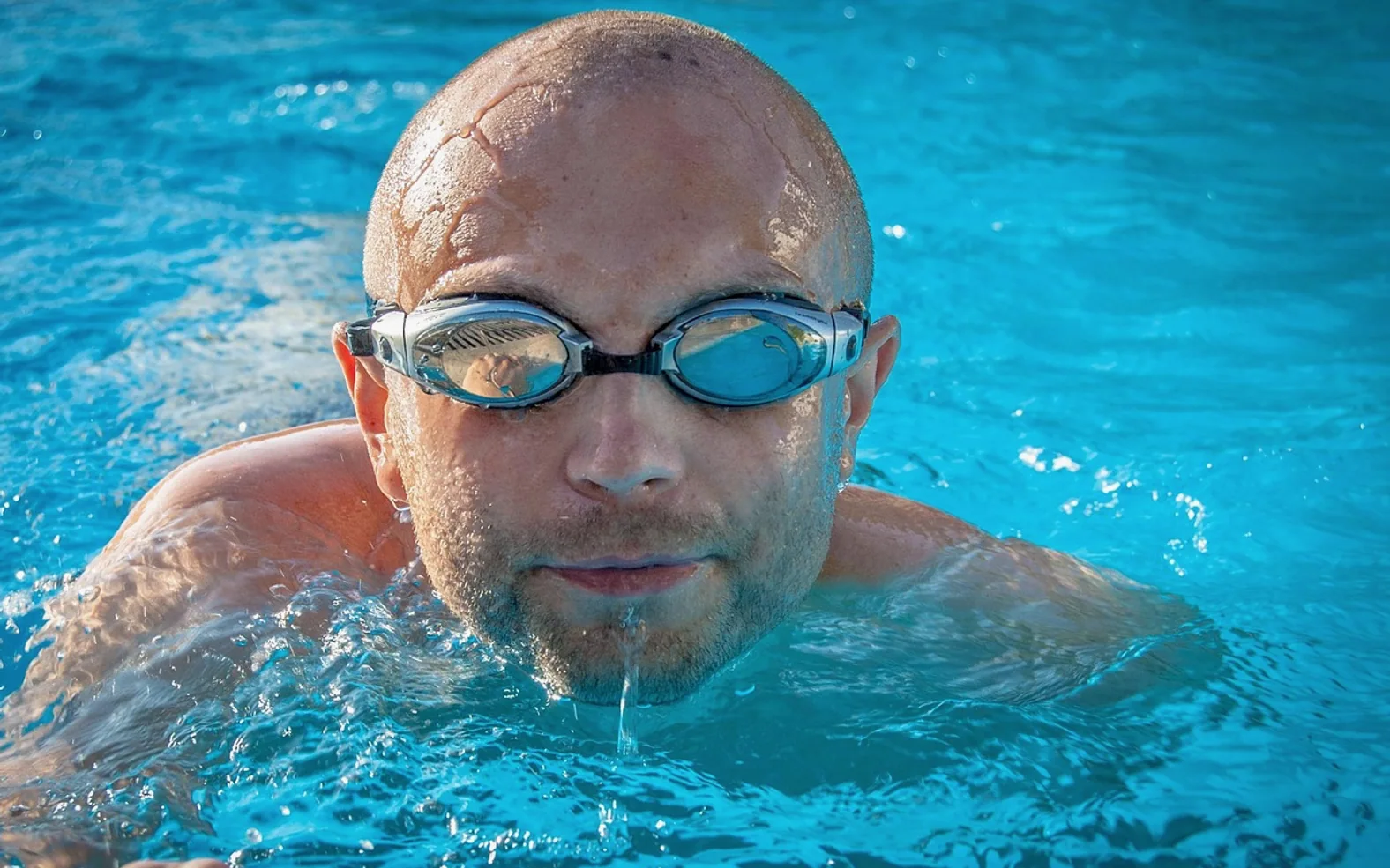 Man, swimmer and pool