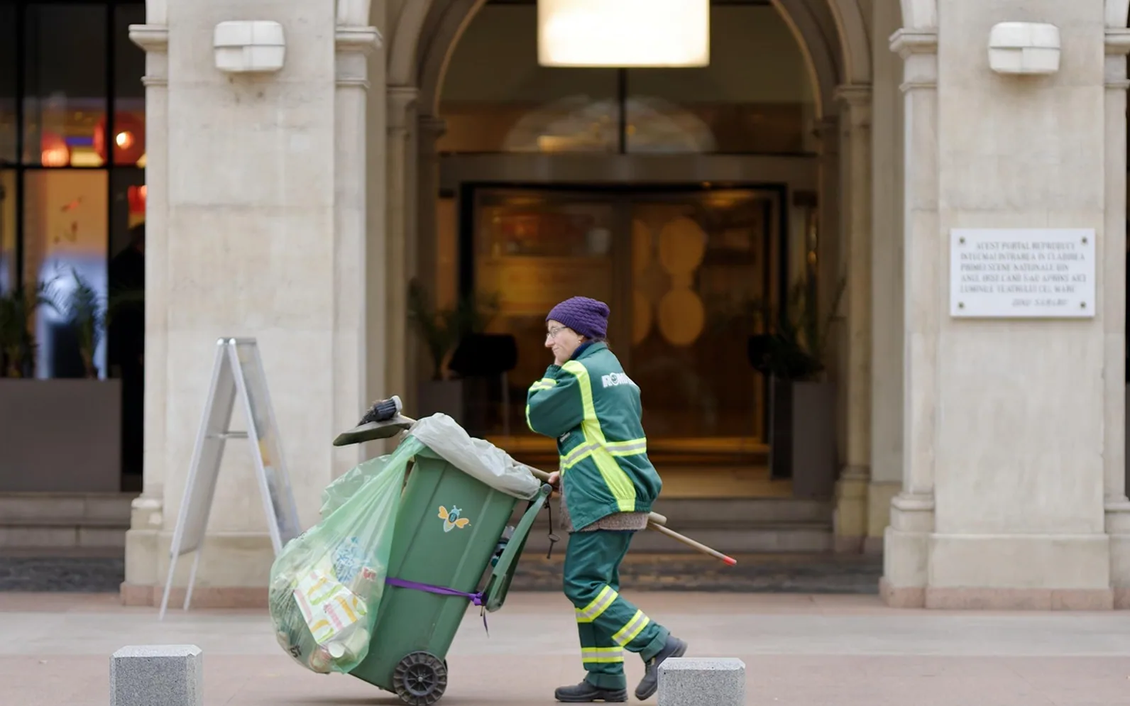 Sanitation worker, city and dumpster